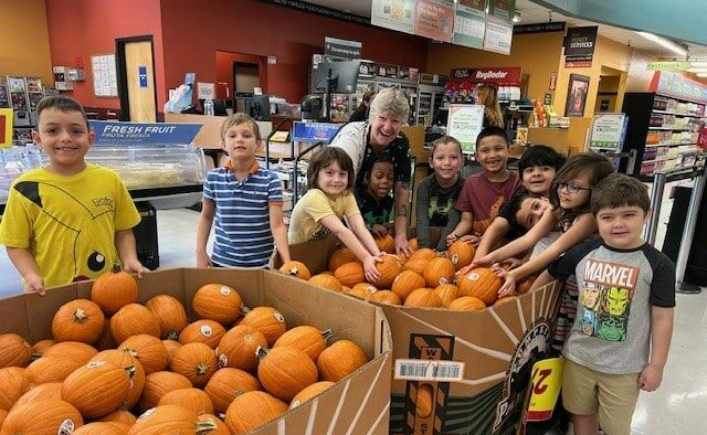 Kids buying pumpkins