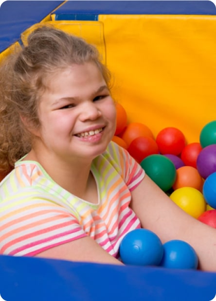 girl playing in ball pit