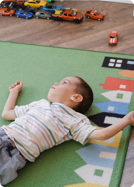cerebral palsy boy laying on playmat